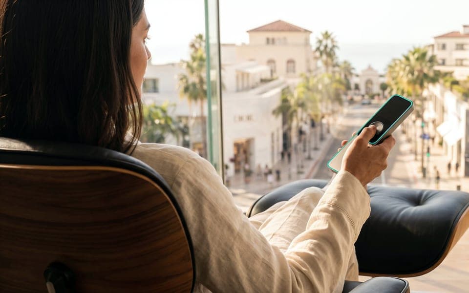 A visitor using the Blicq app on her phone